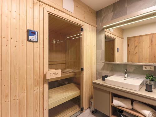 a bathroom with a sink and a mirror at Kitzbüheler Alpenlodge Top A2 in Mittersill