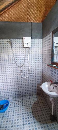 a bathroom with a shower and a sink at Alam Kita in Karimunjawa