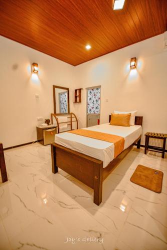 a bedroom with a bed with a wooden ceiling at Eden Udawalawe in Udawalawe