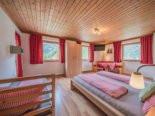 a bedroom with two beds and a table at Falkenstein in Krimml