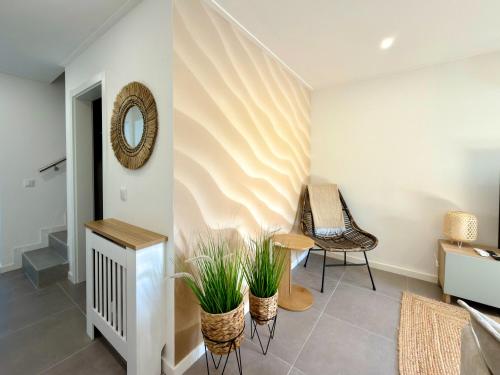 a room with a table and two chairs and a mirror at Alma de Areia - Alma Nossa in Montijo