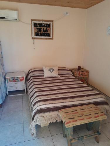 a bedroom with a large bed and a table at La Pradera in Tres Picos