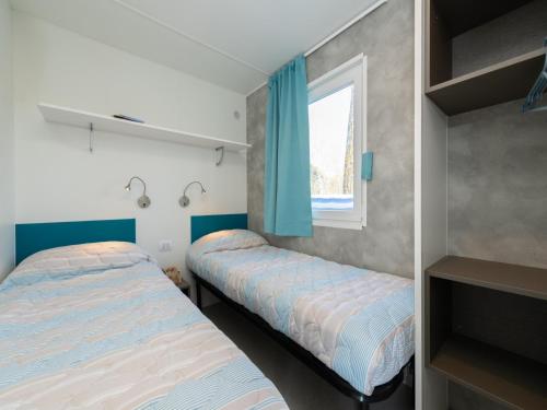 a bedroom with two beds and a window at great mobile home in Cesenatico in Cesenatico