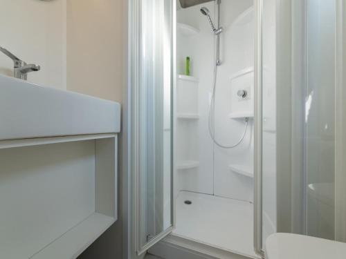 a white bathroom with a shower and a toilet at great mobile home in Cesenatico in Cesenatico