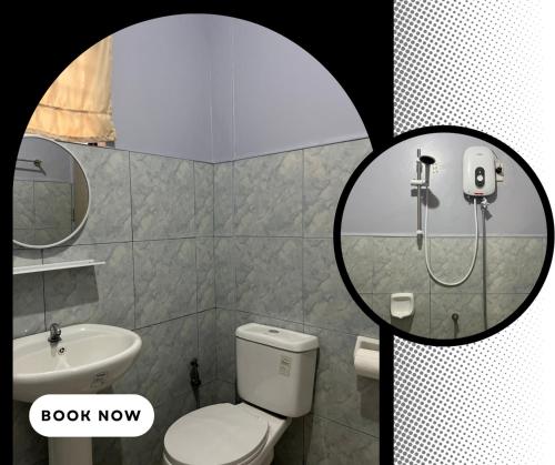 a bathroom with a toilet and a sink and a shower at RobMar Haven in Sibulan