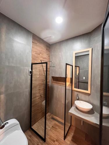 a bathroom with a toilet and a sink and a shower at La Posada del Pastor in Tarapoto