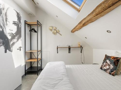 a white bedroom with a bed and a window at Mansion in Aywaille with sauna in Aywaille