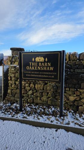 a sign in front of a stone wall at The Estate, Luxury Spacious Family Stay with 3 Hot Tubs, Scenic Views Sleeps 16 near Durham & Bishop Auckland in Durham
