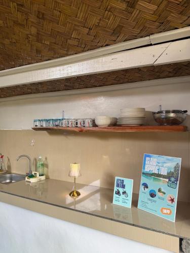 a kitchen counter with a sink and a book at Leianna House in Itaytay
