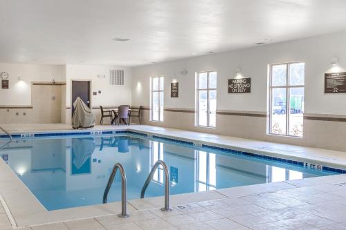a large swimming pool with blue water in a building at MainStay Suites Cartersville in Cartersville