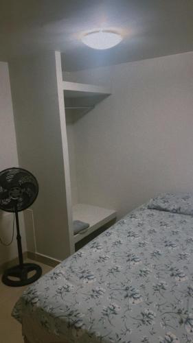 a bedroom with a bed and a chair in it at Pousada 705 Norte 3 in Brasília