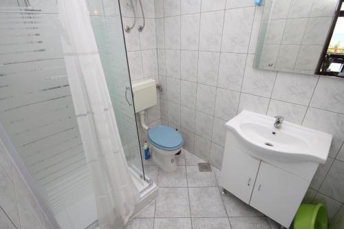 a bathroom with a toilet and a sink and a shower at Apartment Nevidjane 8401a in Neviđane