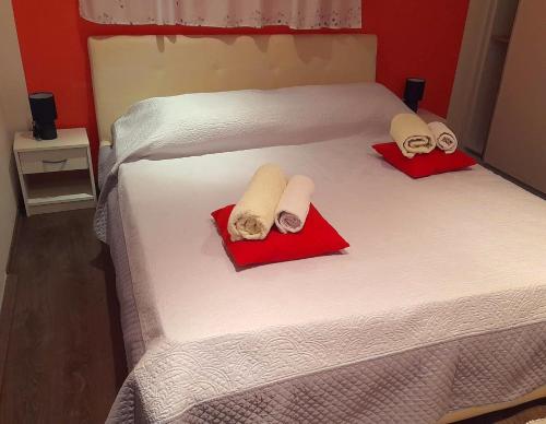 a bed with two towels and two pillows on it at Apartment Zavalatica 184c in Čara