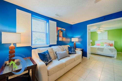 a living room with a couch and a bedroom at Windy Hill Villa A in Myrtle Beach