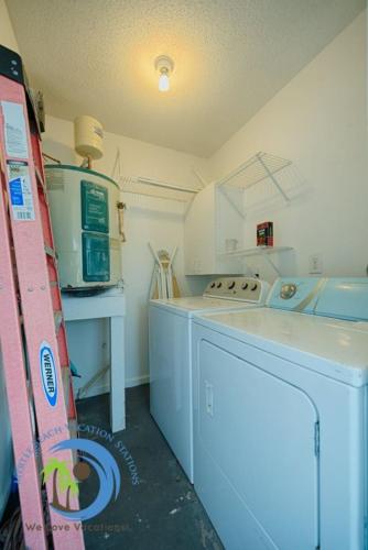 a kitchen with a stove and a washing machine at Windy Hill Villa A in Myrtle Beach