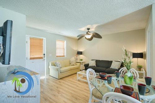 a living room with a couch and a table at Windy Hill Villa 2 - Beach Retreat in Myrtle Beach
