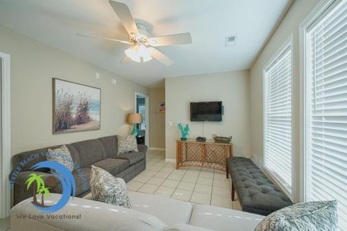 a living room with a couch and a ceiling fan at Sandcastle Down in Myrtle Beach