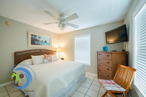 a bedroom with a bed and a ceiling fan at Sandcastle Down in Myrtle Beach