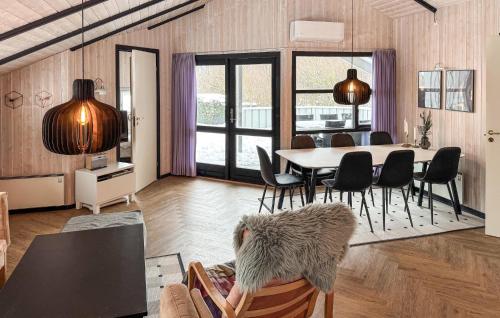 a living room with a dining room table and chairs at Gorgeous Home In Ebeltoft With Sauna in Ebeltoft