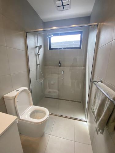a bathroom with a toilet and a glass shower at ULORA Luxury Camp in Wadi Rum