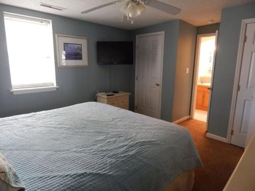 a bedroom with a bed and a flat screen tv at Windy Hill Villa B - Blue Reef in Myrtle Beach