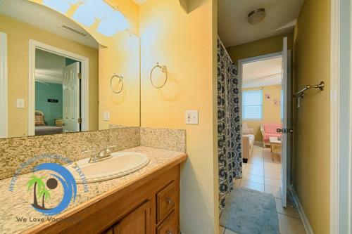 a bathroom with a sink and a mirror at Windy Hill Villa B - Blue Reef in Myrtle Beach