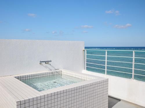 a bath tub with a view of the ocean at CASA DUMAI OceanVilla NAKIJIN in Nakijin