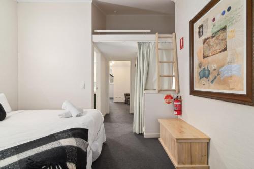 a bedroom with a bed and a refrigerator at Inala 2 in Thredbo