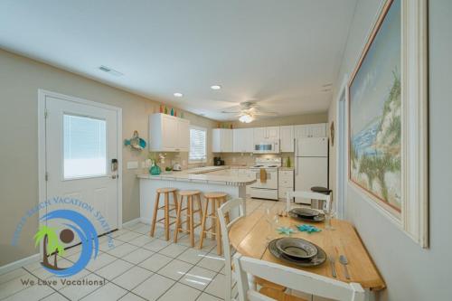 a kitchen and dining room with a table and chairs at Sandcastle Down in Myrtle Beach