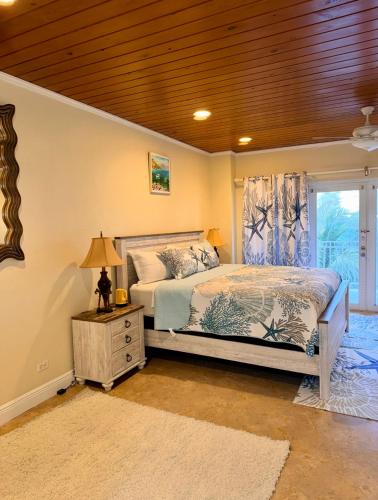 a bedroom with a bed and a table with a lamp at 4 story Ocean Villa in Nassau