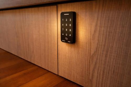 a remote control hanging on a wooden wall at Wink at Upper Cross Street in Singapore