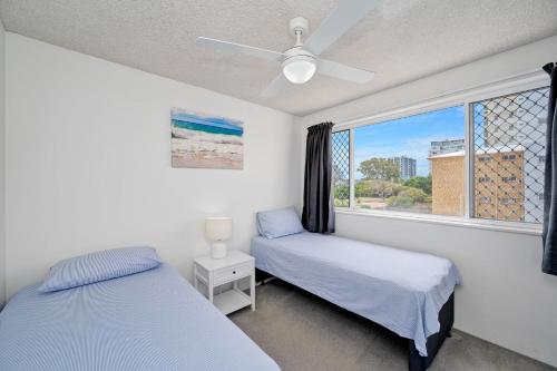a bedroom with two beds and a window at Windbourne unit 4 Golden Beach QLD in Golden Beach