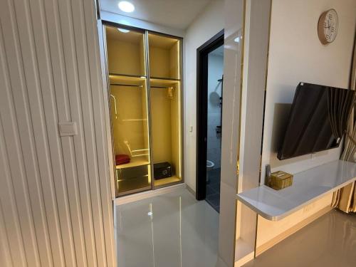 a room with a tv and a glass door at RV-Villa 4 bedrooms&Private Pool in Pulau Sembakau Kecil