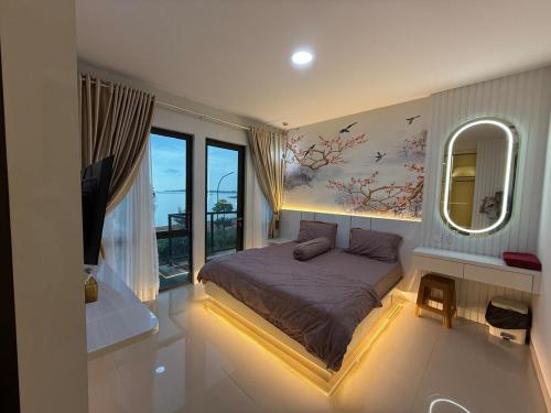 a bedroom with a large bed and a mirror at RV-Villa 4 bedrooms&Private Pool in Pulau Sembakau Kecil