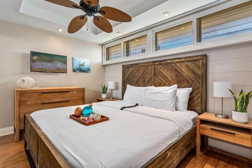 a bedroom with a large bed with a ceiling fan at Lahaina Roads 209 in Lahaina