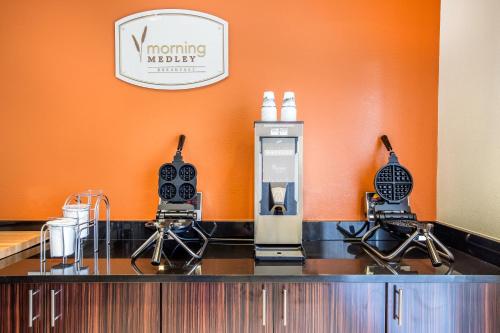 a hair salon counter with a machine and two stools at MainStay Suites Cartersville in Cartersville