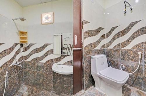 a bathroom with a toilet and a sink at Gold Hotel in Faridabad