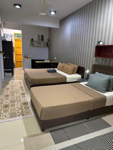 a bedroom with two beds in a room at Ayden roomstay in Kampar