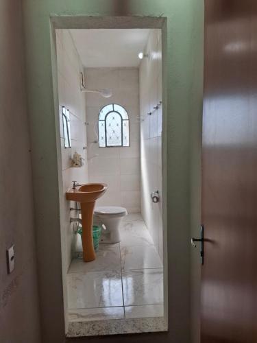 a bathroom with a sink and a toilet at Suite confort 02 in Contagem