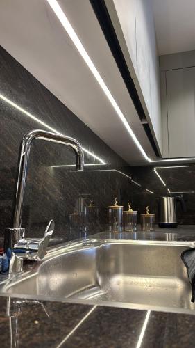 a kitchen sink with a faucet on top of it at Crown Mountain in 6th Of October