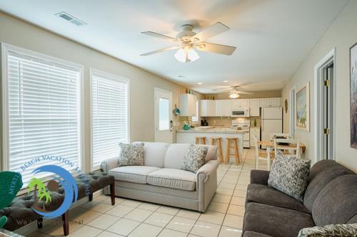 a living room with a couch and a ceiling fan at Sandcastle Down in Myrtle Beach