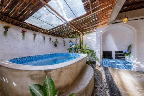 a large bath tub in a room with plants at Teewana Resort Chiang Mai in Chiang Mai