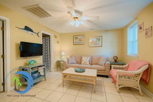 a living room with a couch and a tv at Windy Hill Villa B - Blue Reef in Myrtle Beach