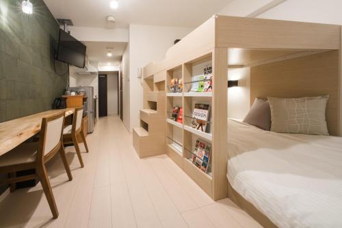 a bedroom with a bed and a desk and a table at Hotel Axas Nihonbashi in Tokyo