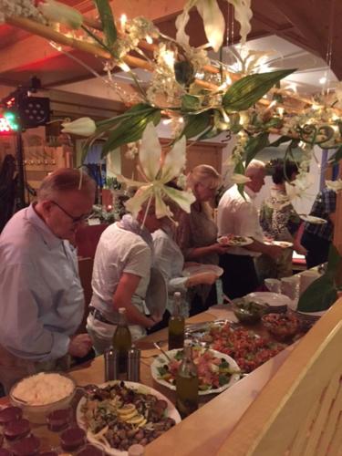 a group of people standing in a kitchen preparing food at Hotel und Restaurant Piccolo in Thale