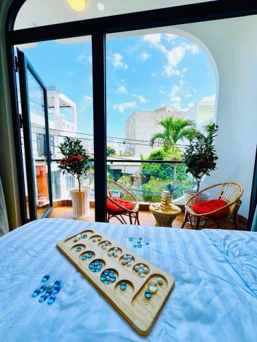 a remote control sitting on top of a bed with a window at Punica Homestay in Tuy Hoa