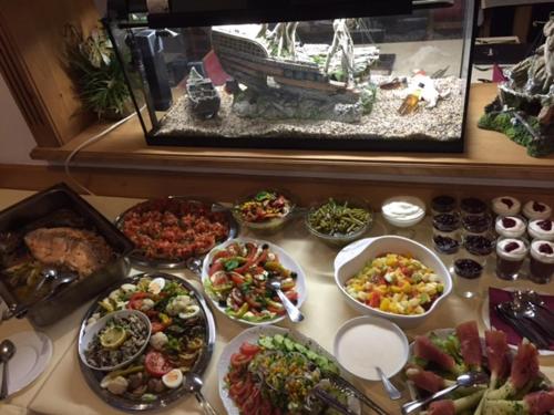 a buffet with many different types of food on a table at Hotel und Restaurant Piccolo in Thale