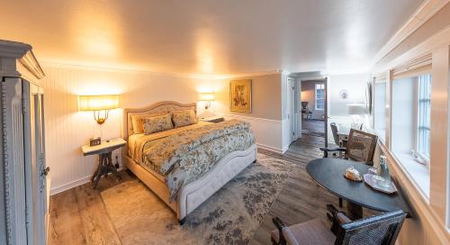 a bedroom with a bed and a desk and a table at Dungeness Barn House Bed and Breakfast at Two Crows Farm in Sequim