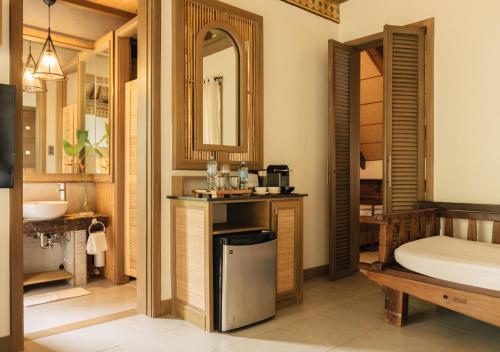 a bathroom with a sink and a mirror at Vivere Azure in Batangas City