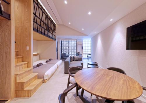 a living room with a couch and a table at Sakura Cross Inn & Sauna Ishigaki in Ishigaki Island